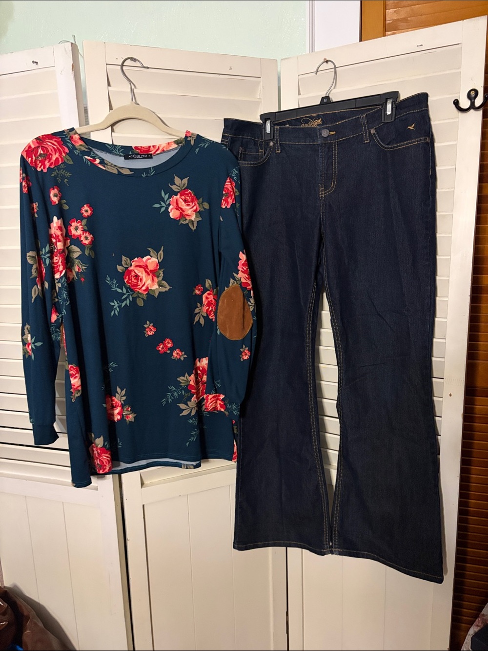 Two piece outfit including Grane bootcut jeans and an ActingPro top with patches